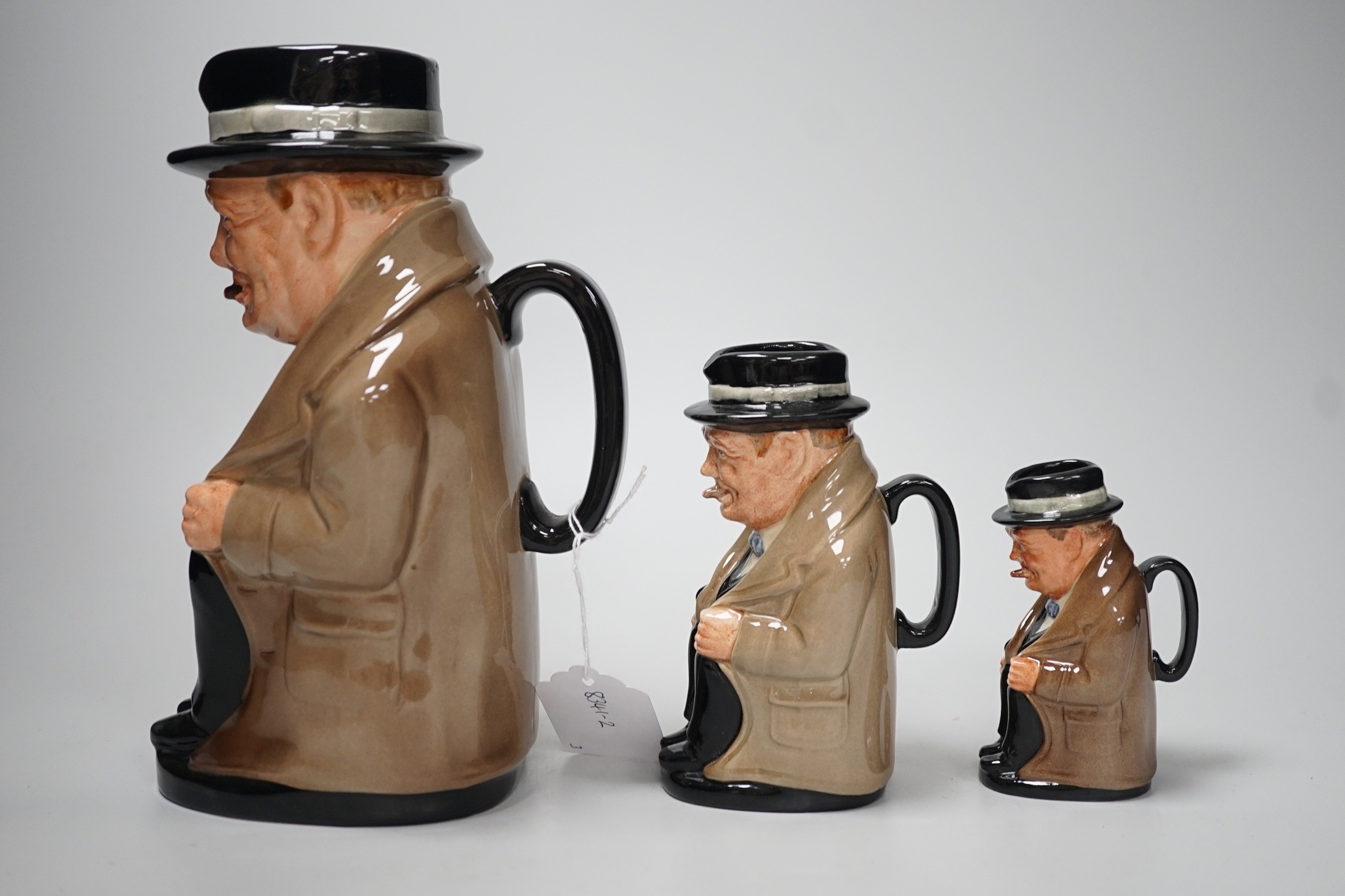 Three graduated Royal Doulton 'Churchill' character jugs, 23cm